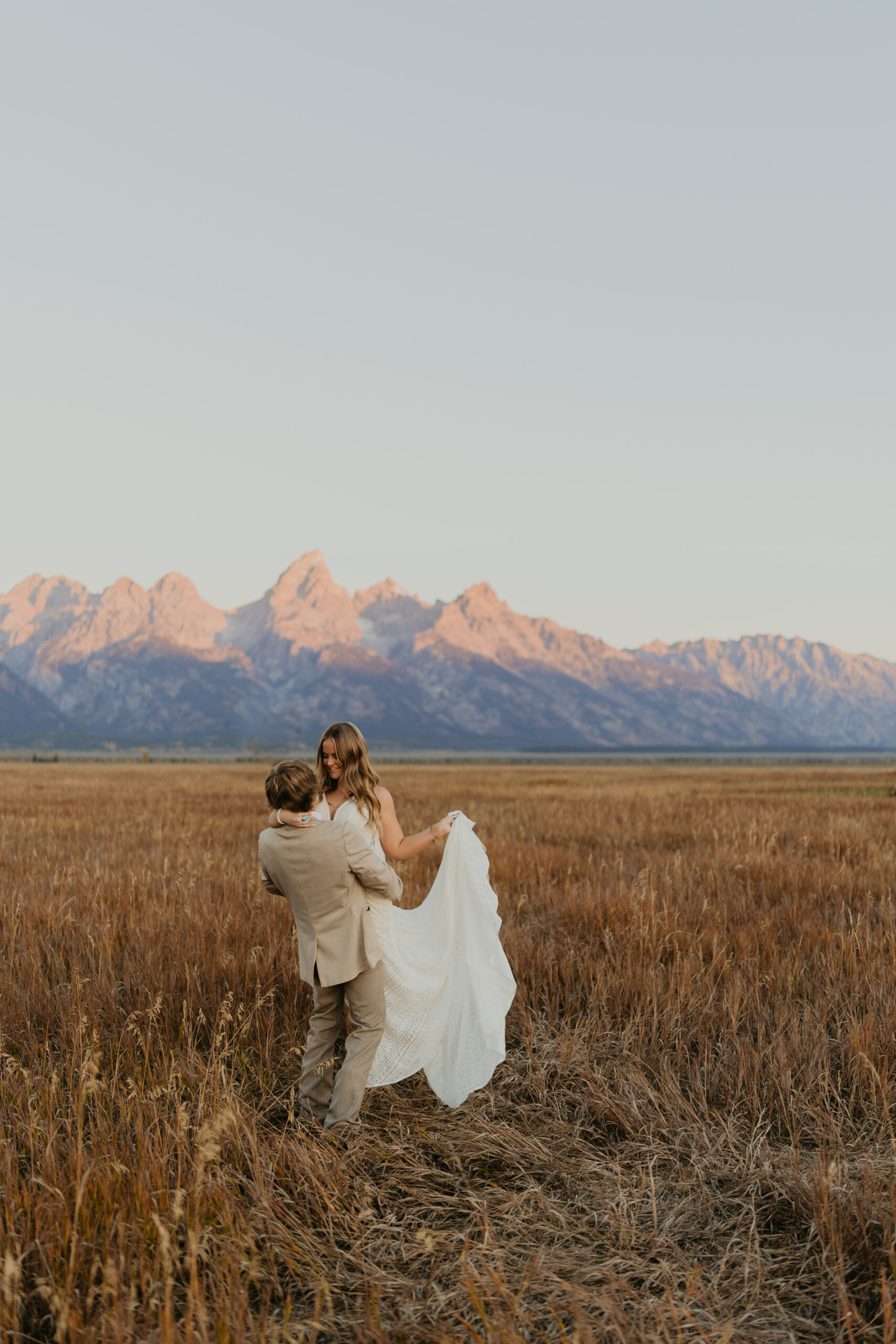 a couple in front of the grand teton national park