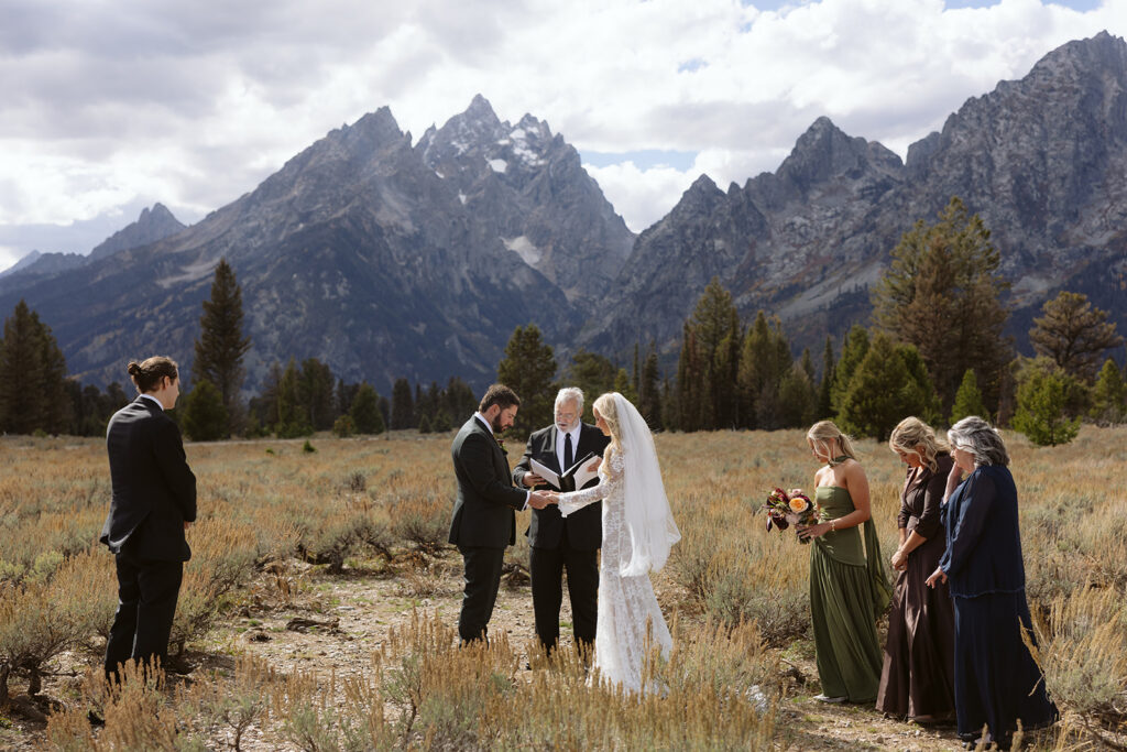 A couple during their elopement ceremony at Mountain View Turnout in Grand Teton National Park