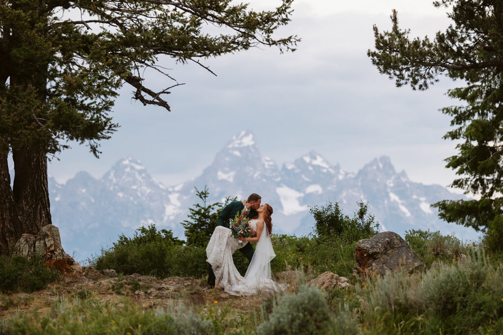 A couple kissing during the wedding ceremony at The Wedding Tree in Wyoming