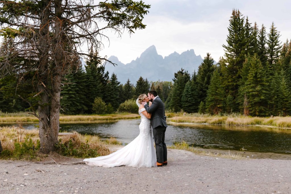 A couple having their first kiss at their Grand Teton National Park Elopement