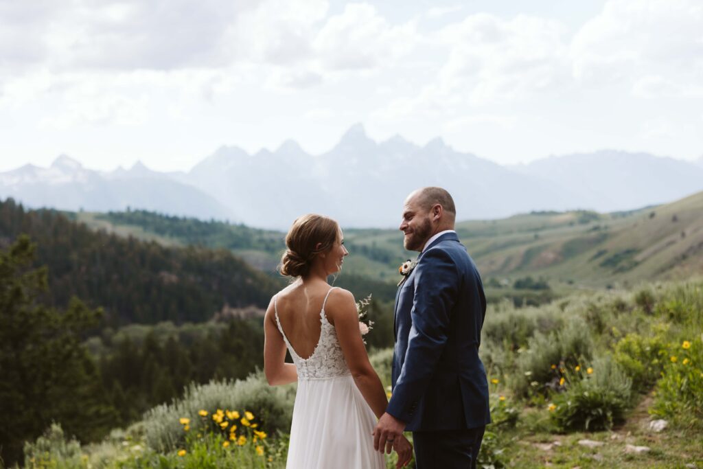 couple admiring each other at the wedding tree in Jackson hole wyoming