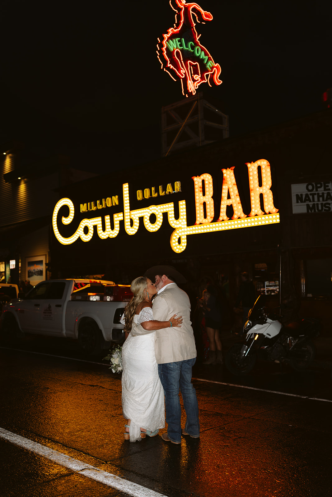 couple kissing in front of the cowboy bar in jackson wy