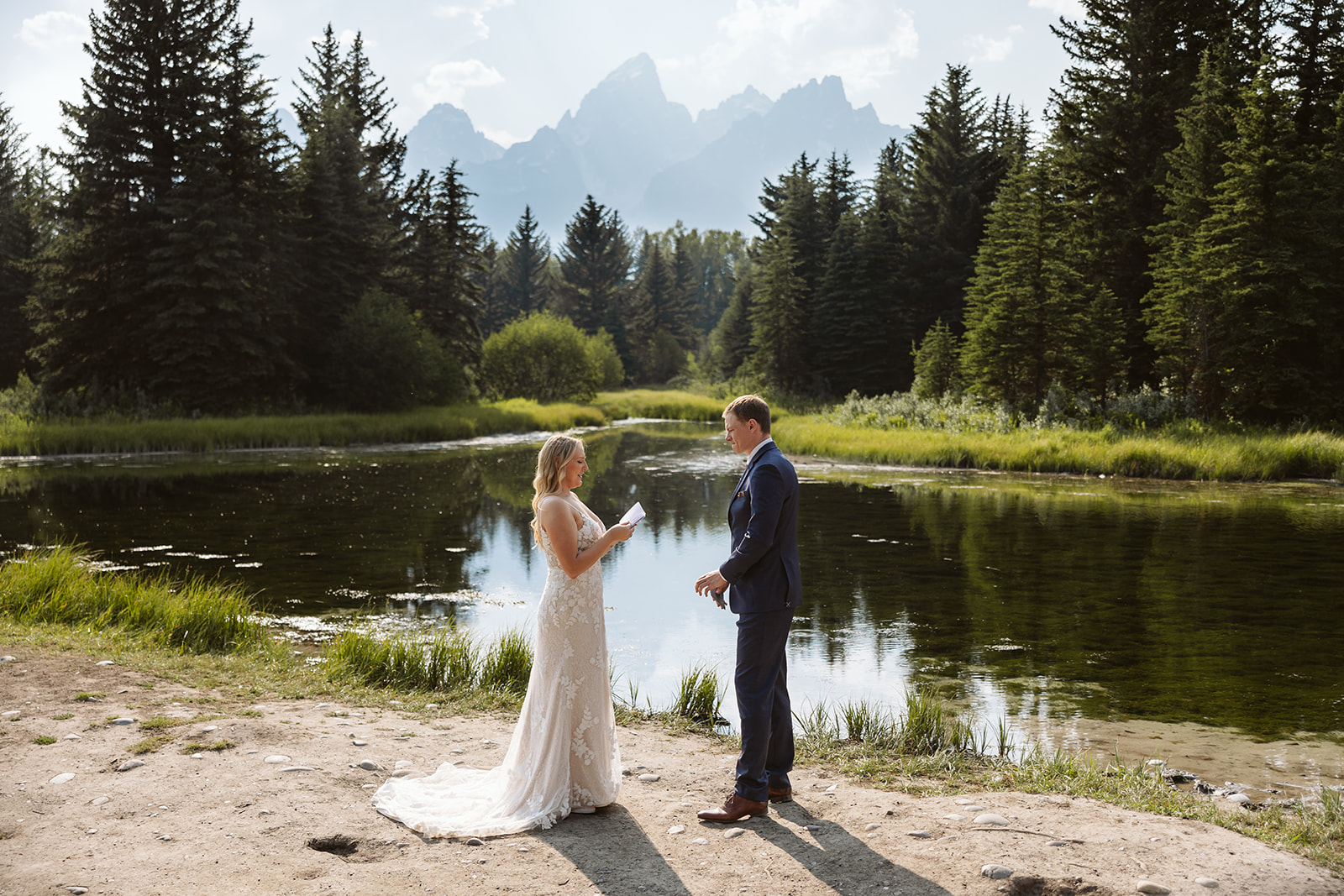 couple exchanging vows at schwabacher landing in grand teton national park