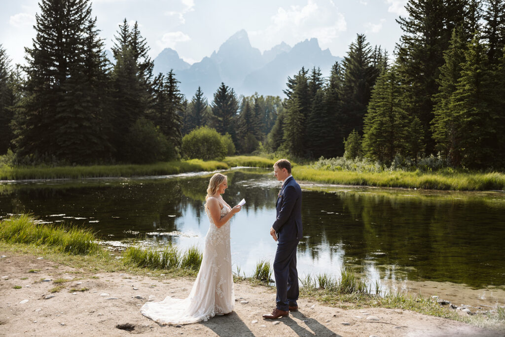 A couple during their elopement ceremony at Schwabacher Landing in Grand Teton National Park