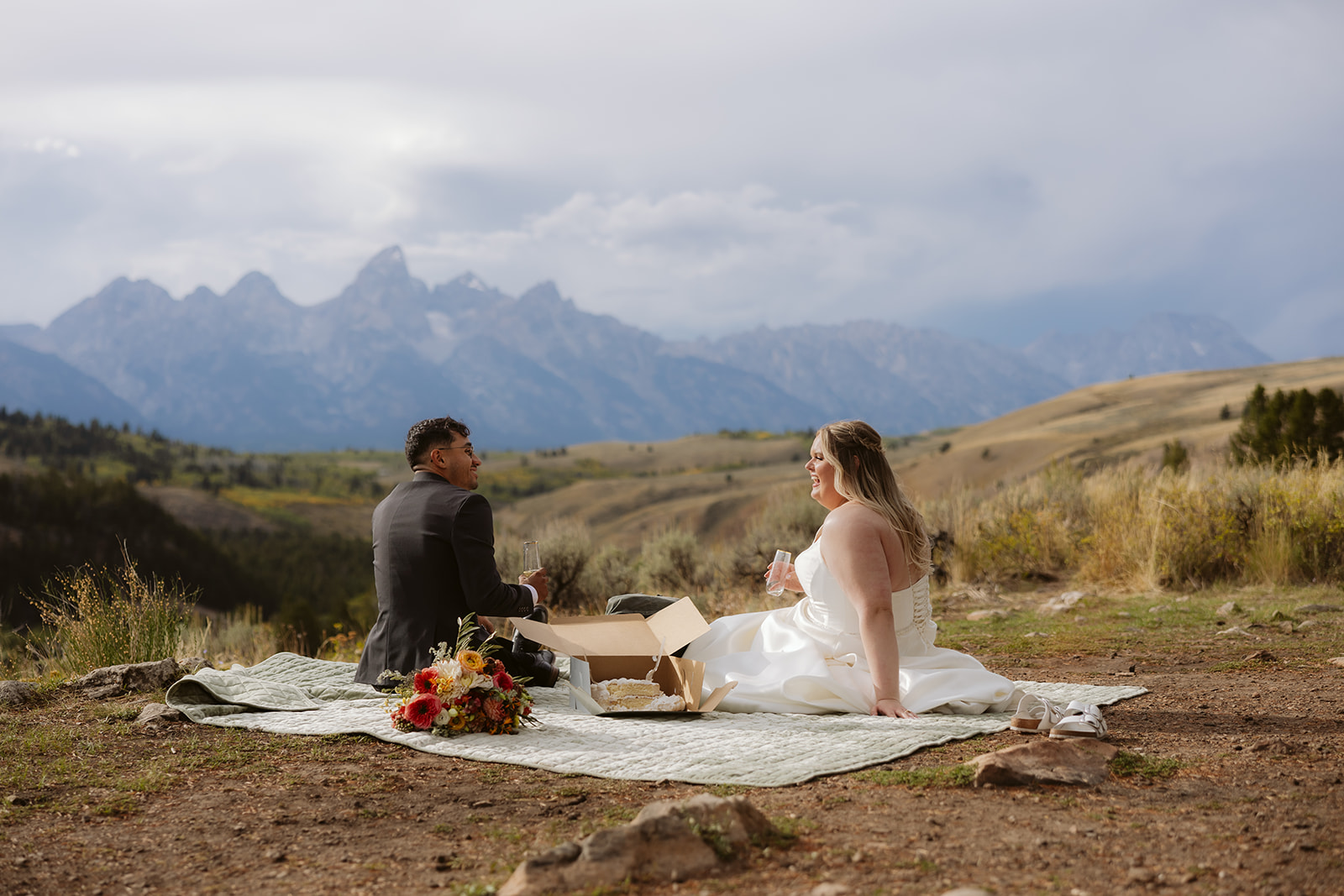 A couple having a picnic after their wedding ceremony at the wedding tree in wyoming