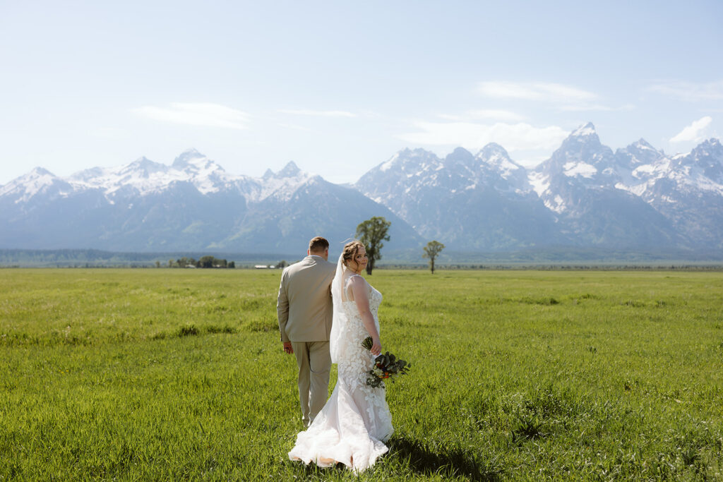 A couple on their summer wedding day at Mormon Row in Jackson Hole Wyoming