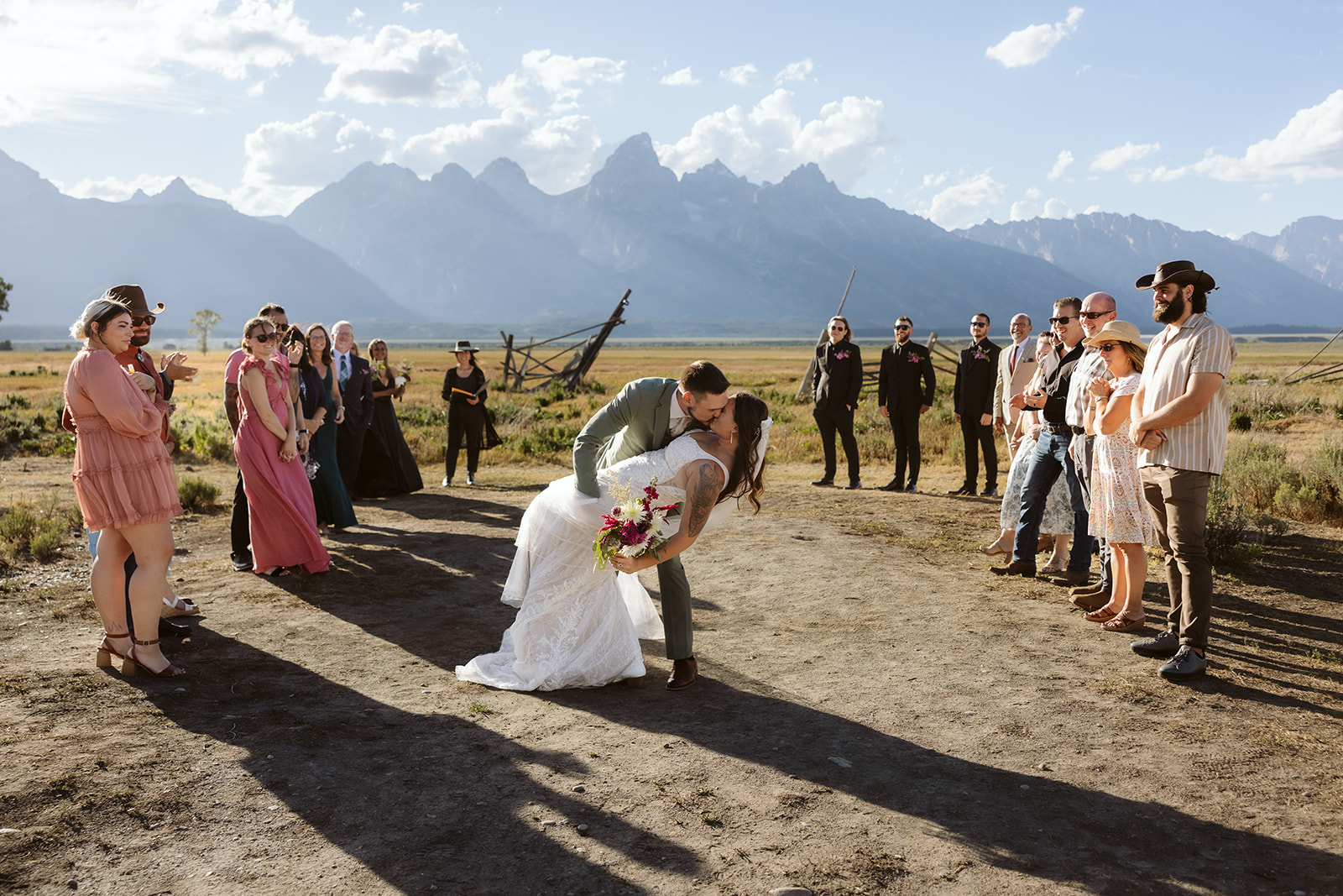 A couple kissing during their wedding ceremony at Mormon Row in Grand Teton National Park
