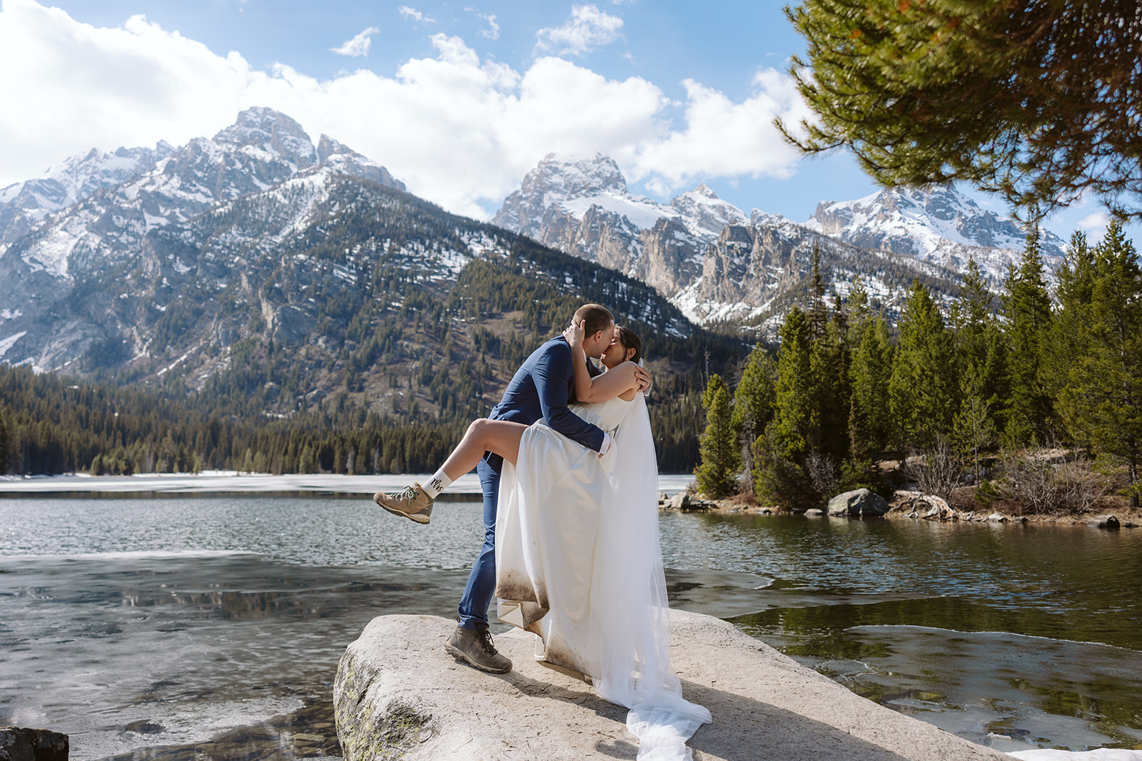 A couple during their elopement ceremony at Taggart Lake in Grand Teton National Park in May