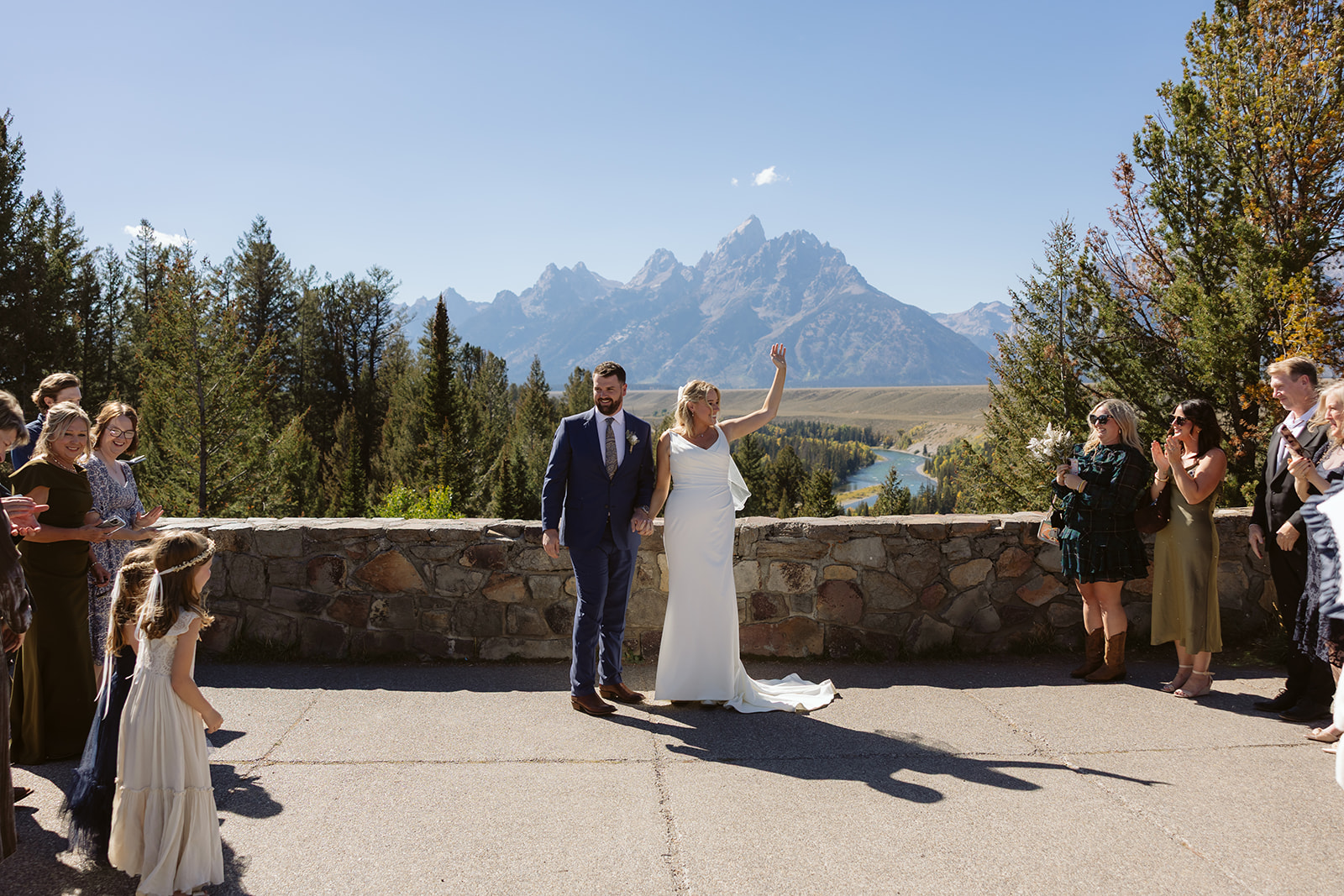 A couple during their wedding ceremony at snake river overlook in grand teton national park